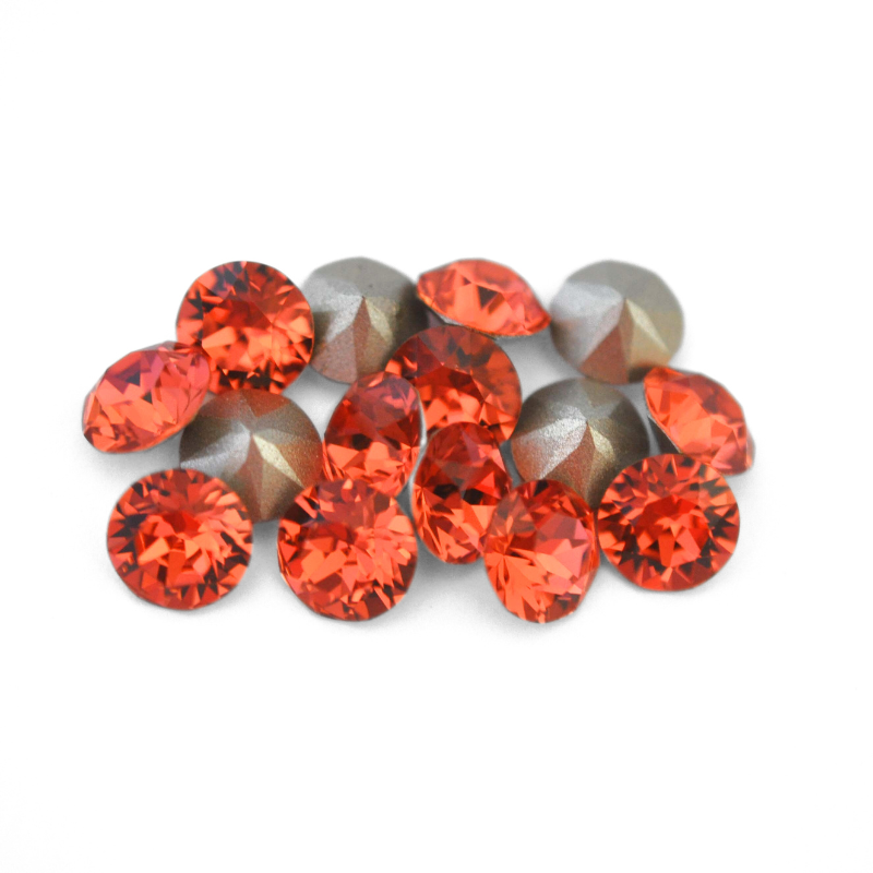 Round faceted Austrian crystal rhinestones in the color Padparadscha displayed on a white background.