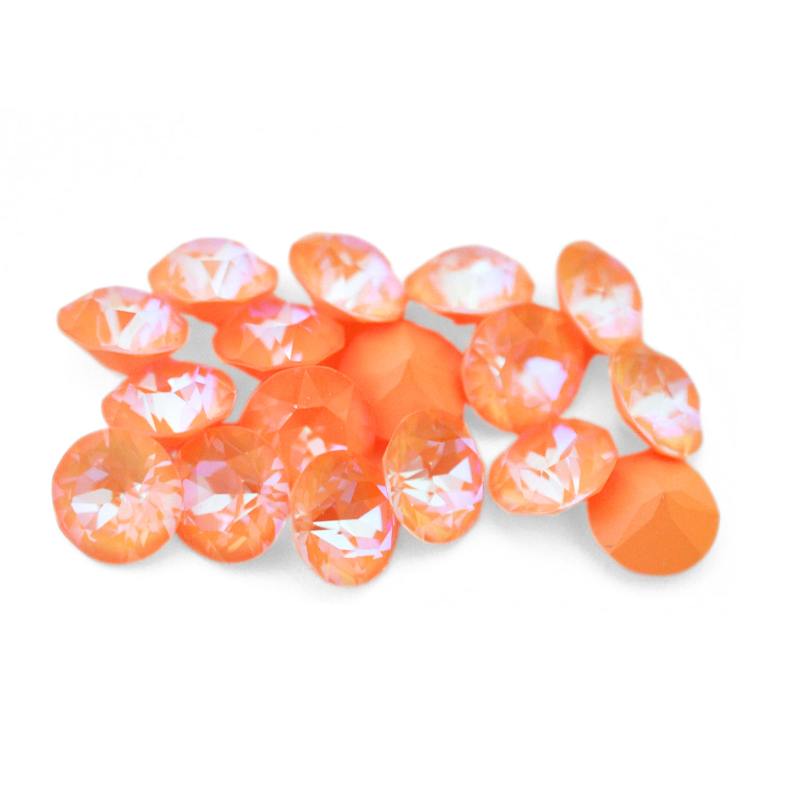 Round faceted Austrian crystal rhinestones in the color Peach Delite displayed on a white background.