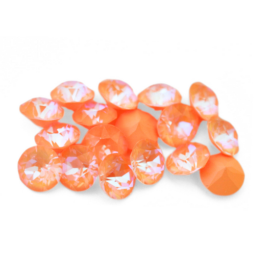 Round faceted Austrian crystal rhinestones in the color Peach Delite displayed on a white background.
