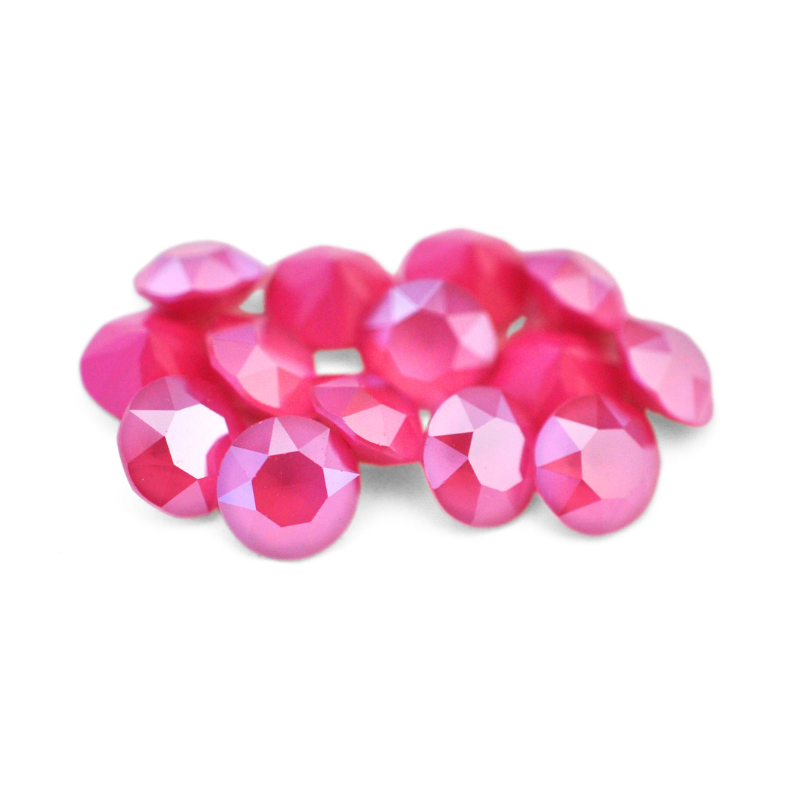 Round faceted Austrian crystal rhinestones in the color Peony Pink displayed on a white background.