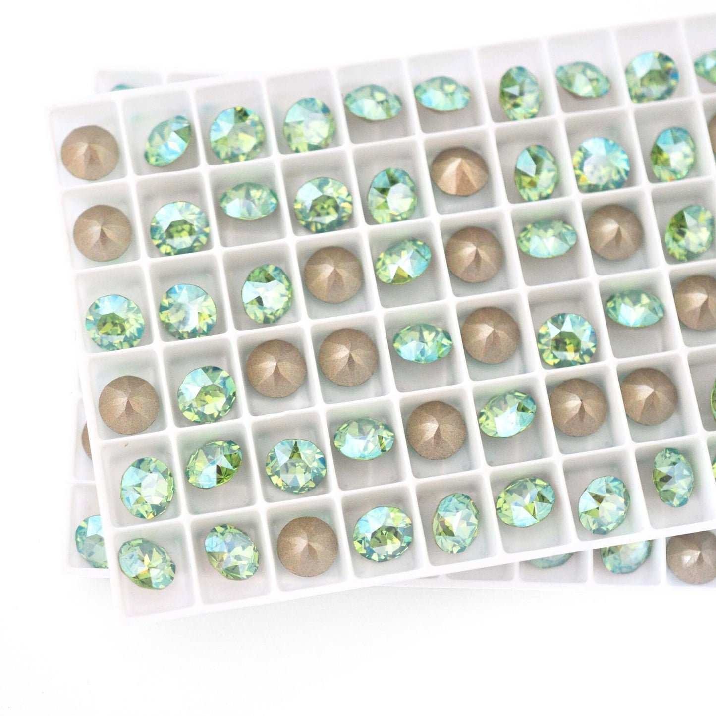 Round faceted Austrian crystal rhinestones in the color Peridot Moonlight displayed in a tray