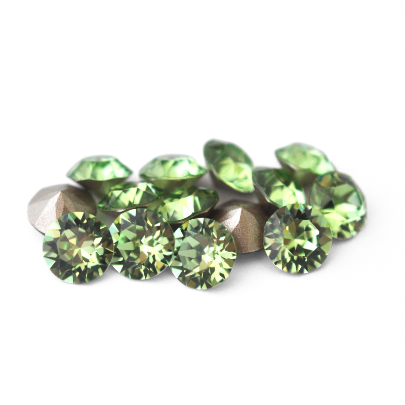 Round faceted Austrian crystal rhinestones in the color Peridot displayed on a white background.