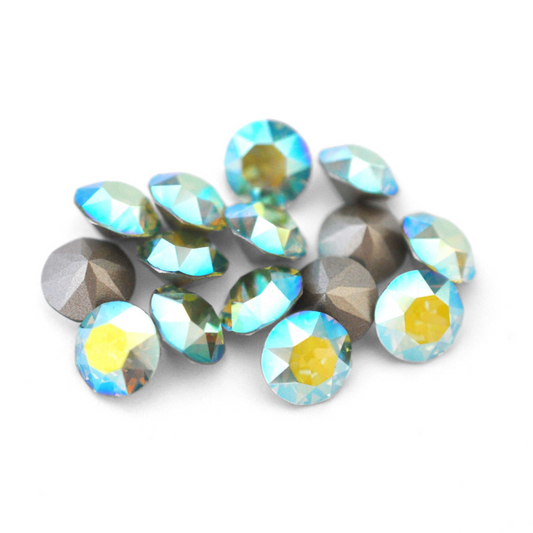 Round faceted Austrian crystal rhinestones in the color Peridot AB displayed on a white background.