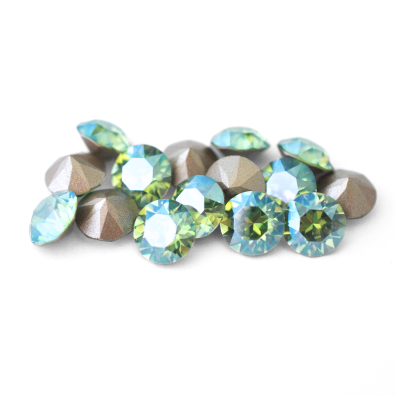 Round faceted Austrian crystal rhinestones in the color Peridot Moonlight displayed on a white background.