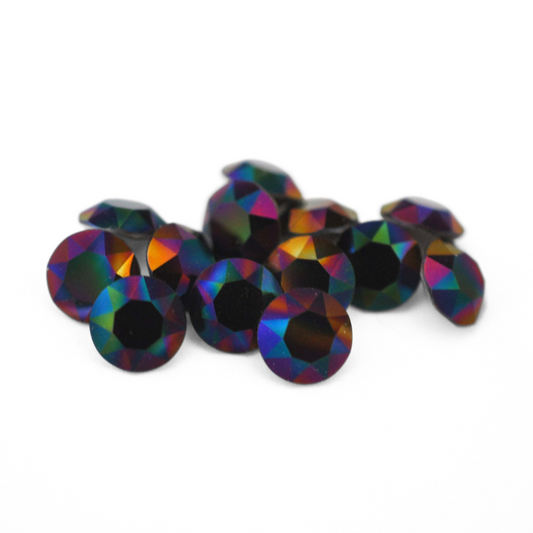 Round faceted Austrian crystal rhinestones in the color Rainbow Dark displayed on a white background.