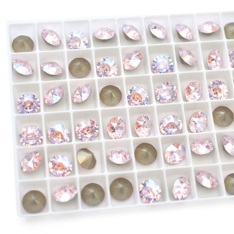 Round faceted Austrian crystal rhinestones in the color Rosaline Moonlight displayed in a tray.