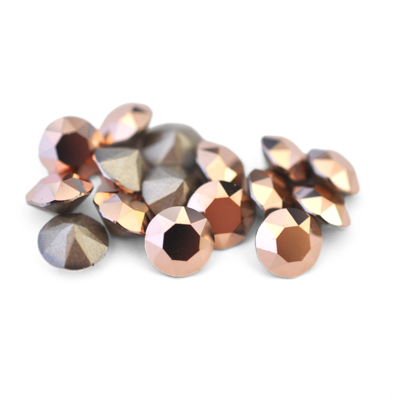 Round faceted Austrian crystal rhinestones in the color Rose Gold displayed on a white background.