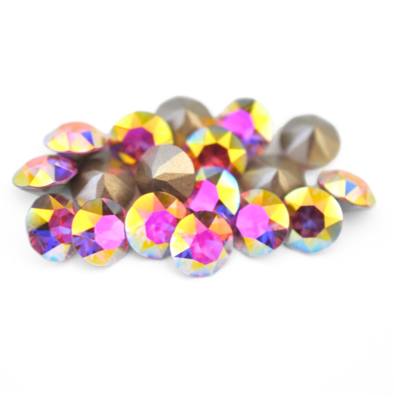 Round faceted Austrian crystal rhinestones in the color Rose Transmission displayed on a white background.
