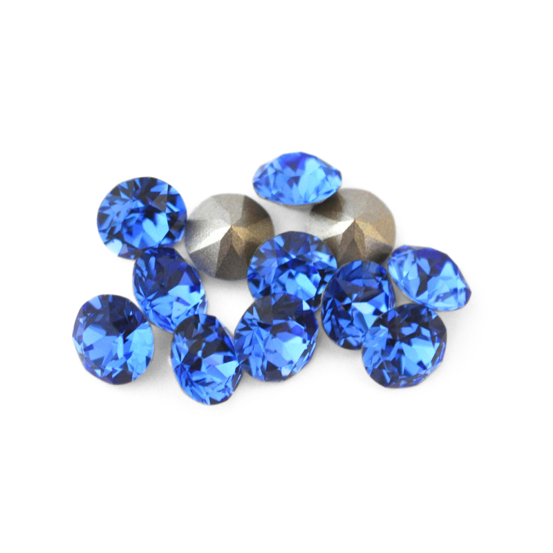 Round faceted Austrian crystal rhinestones in the color Sapphire displayed on a white background