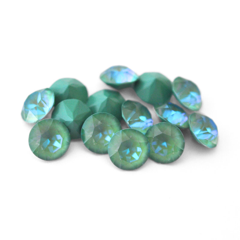 Round faceted Austrian crystal rhinestones in the color Silky Sage Delite displayed on a white background.