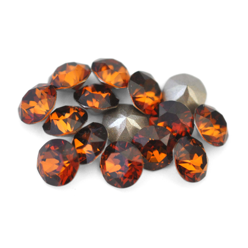 Round faceted Austrian crystal rhinestones in the color Smoked Amber displayed on a white background.