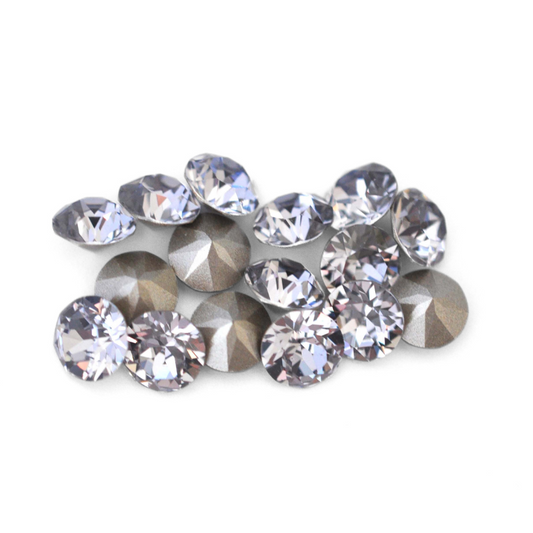 Round faceted Austrian crystal rhinestones in the color Smoky Mauve displayed on a white background.