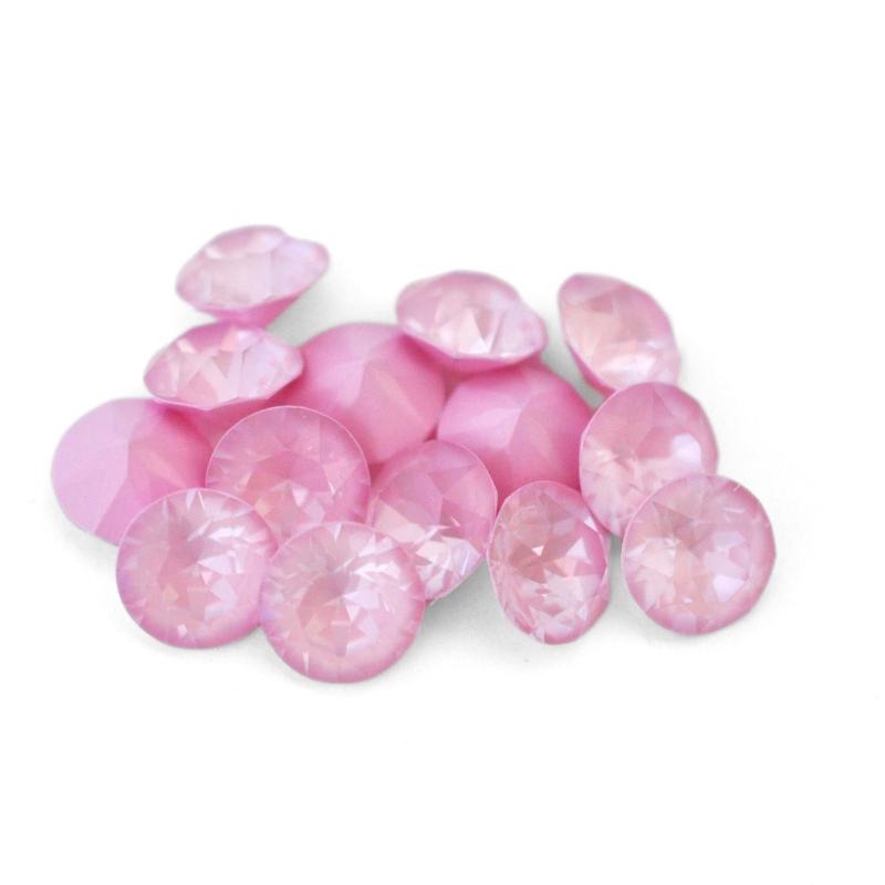 Round faceted Austrian crystal rhinestones in the color Soft Rose Ignite displayed on a white background.