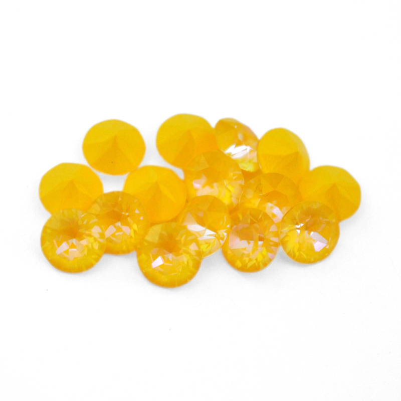 Round faceted Austrian crystal rhinestones in the color Sunshine Delite displayed on a white background.
