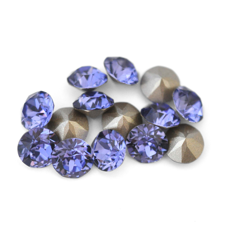 Round faceted Austrian crystal rhinestones in the color Tanzanite displayed on a white background.