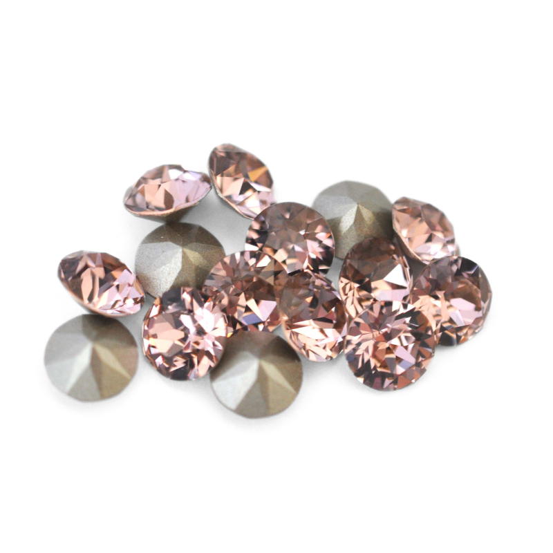 Round faceted Austrian crystal rhinestones in the color Vintage Rose displayed on a white background.