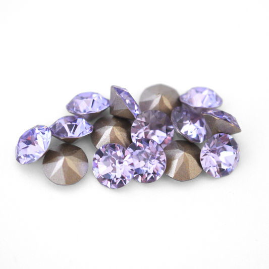 Round faceted Austrian crystal rhinestones in the color Violet displayed on a white background.