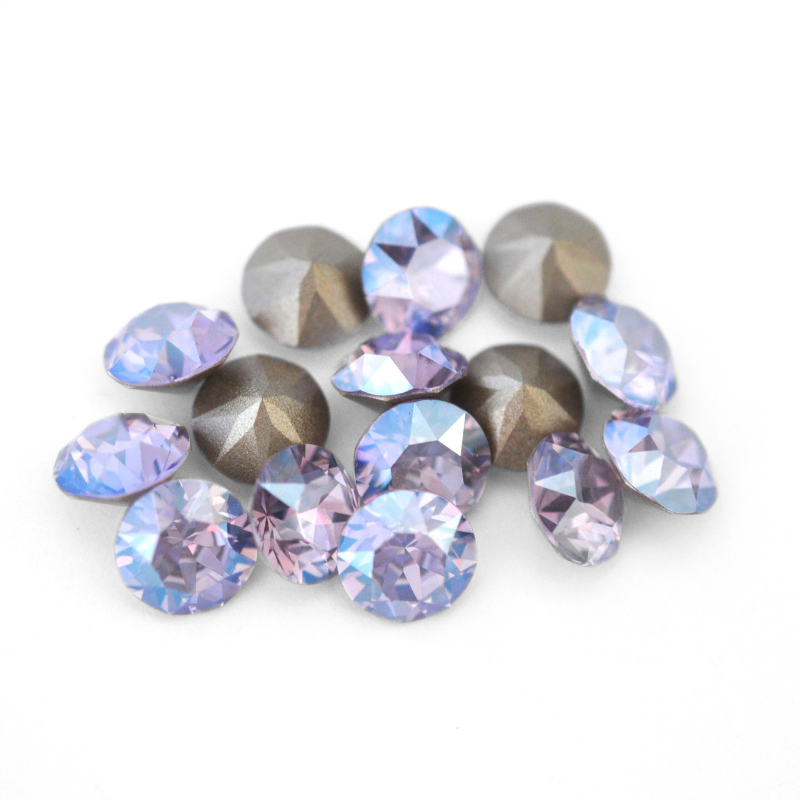 Round faceted Austrian crystal rhinestones in the color Violet Moonlight displayed on a white background.