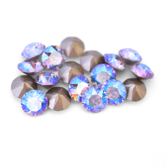 Round faceted Austrian crystal rhinestones in the color Violet Shimmer displayed on a white background.