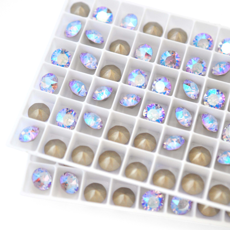Round faceted Austrian crystal rhinestones in the color Violet Shimmer in a tray.
