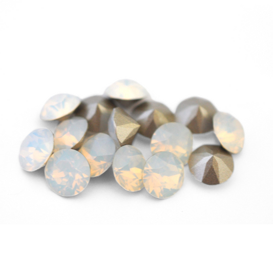 Round faceted Austrian crystal rhinestones in the color White Opal displayed on a white background.
