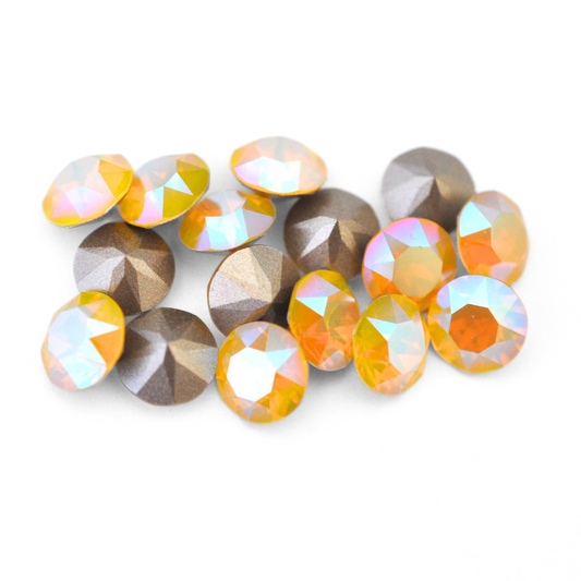 Round faceted Austrian crystal rhinestones in the color Yellow Opal Shimmer displayed on a white background.