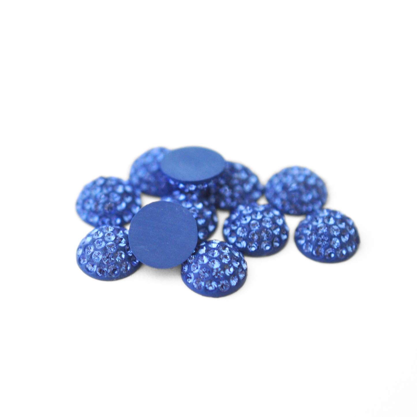 Round Pave Cabochons with Austrian crystal rhinestones in the color Sapphire displayed on a white background