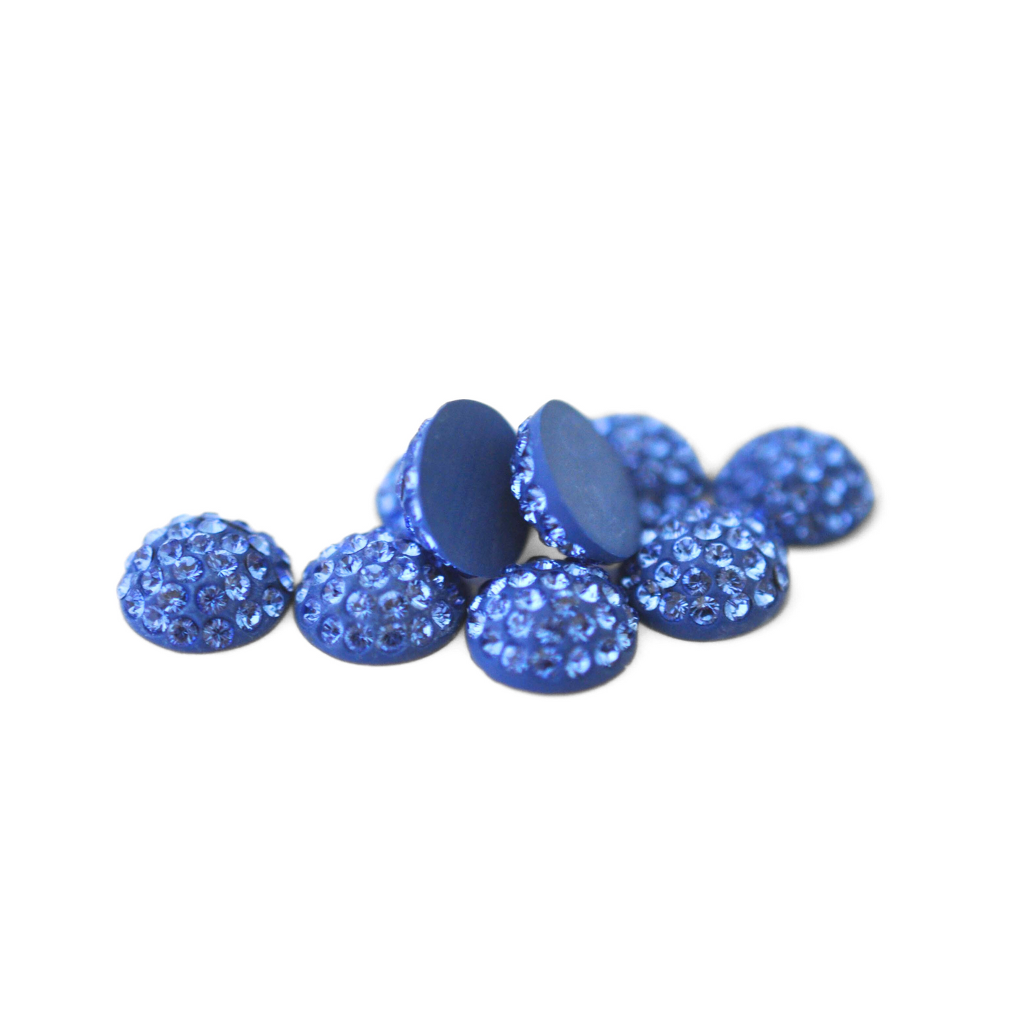 Round Pave Cabochons with Austrian crystal rhinestones in the color Sapphire displayed on a white background