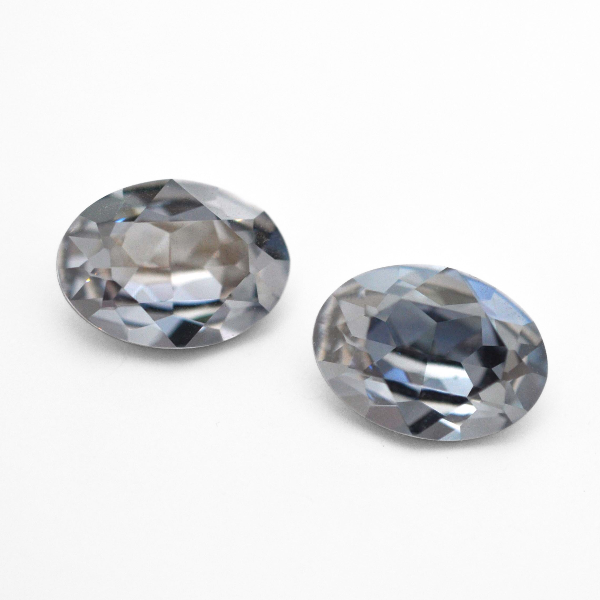 Oval shape faceted Austrian crystal rhinestones in the color Blue Shade displayed on a white background.