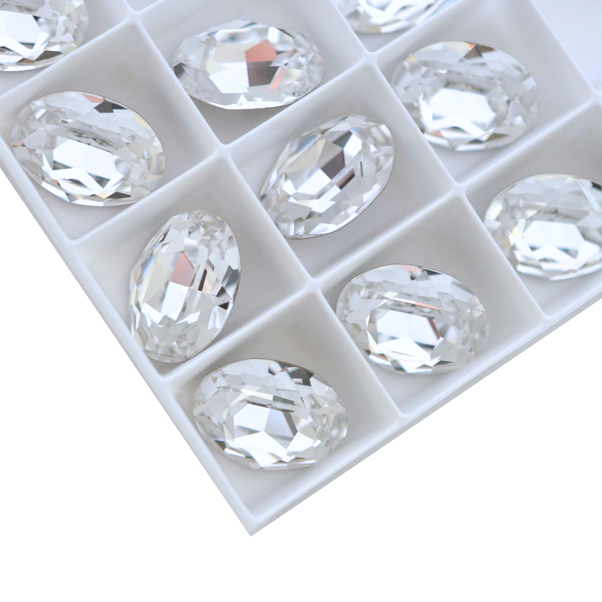 Oval shape faceted Austrian crystal rhinestones in the color Crystal displayed on a white background. 