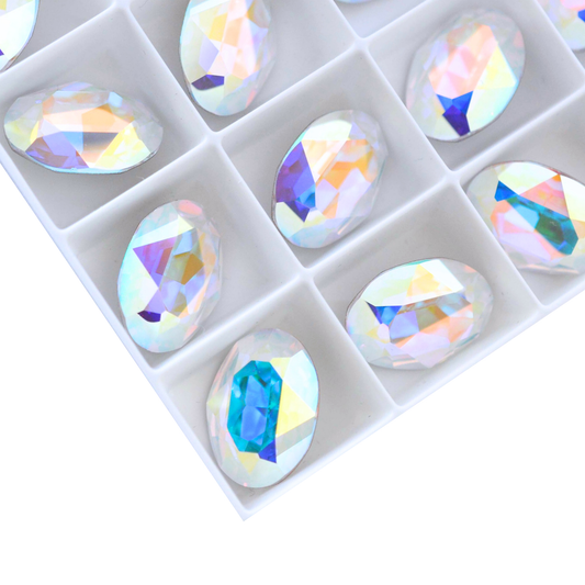 Oval shape faceted Austrian crystal rhinestones in the color Crystal AB displayed on a white background.