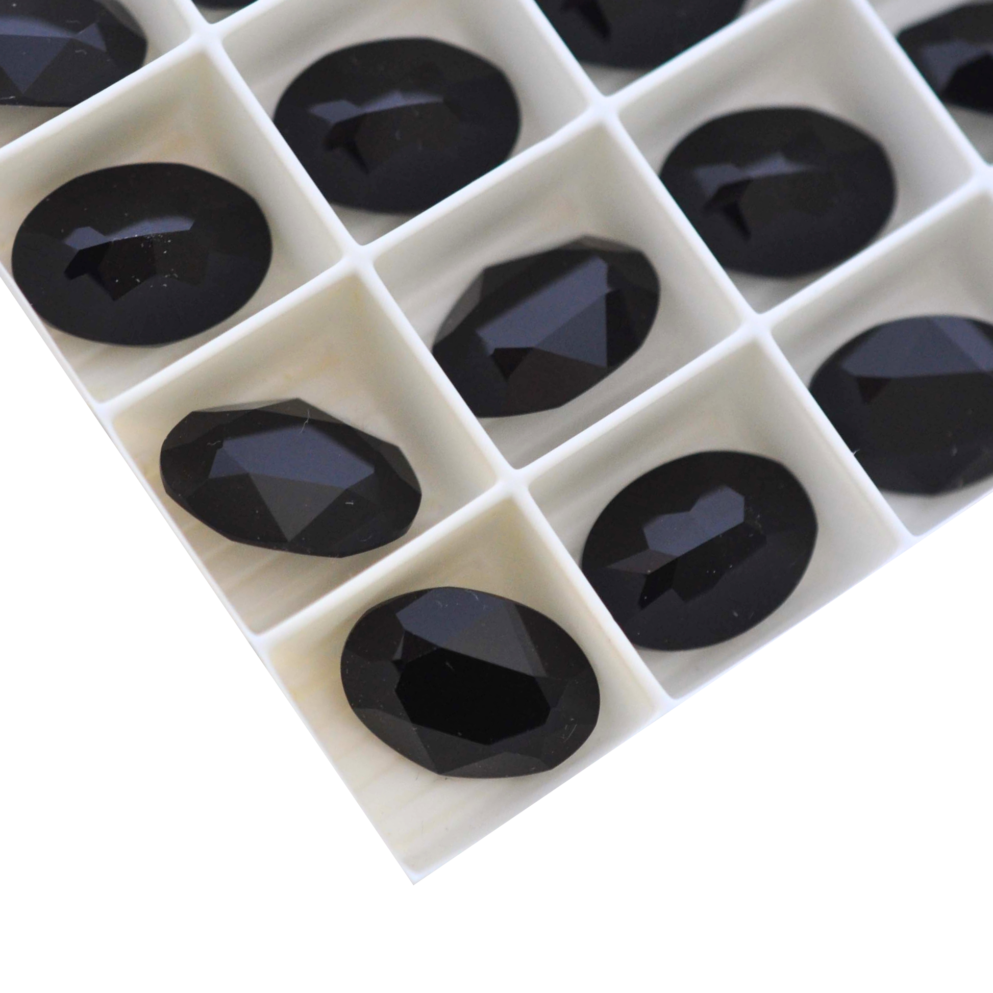 Oval shape faceted Austrian crystal rhinestones in the color Jet displayed on a white background.