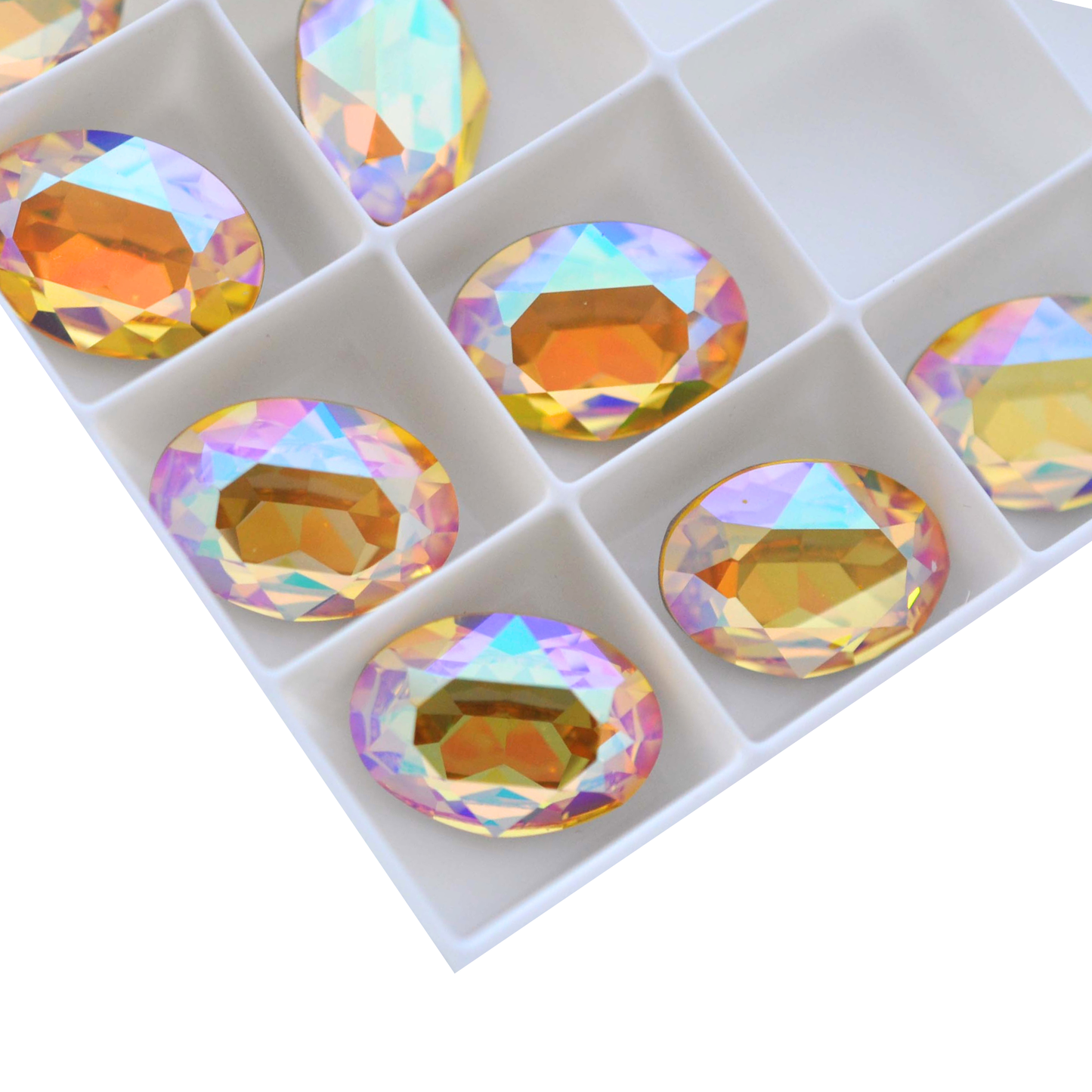 Oval shape faceted Austrian crystal rhinestones in the color Light Topaz Glacier Blue displayed on a white background.