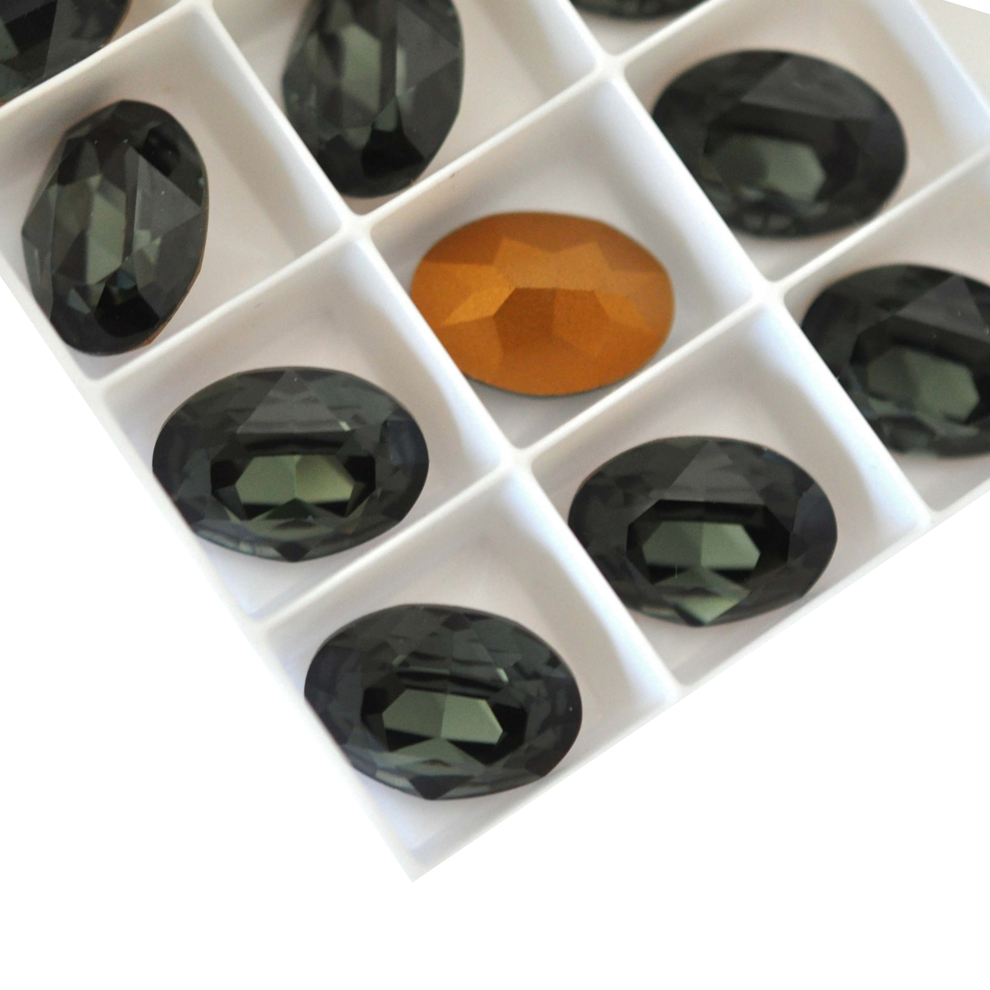 Oval shape faceted Austrian crystal rhinestones in the color Morion displayed on a white background. 