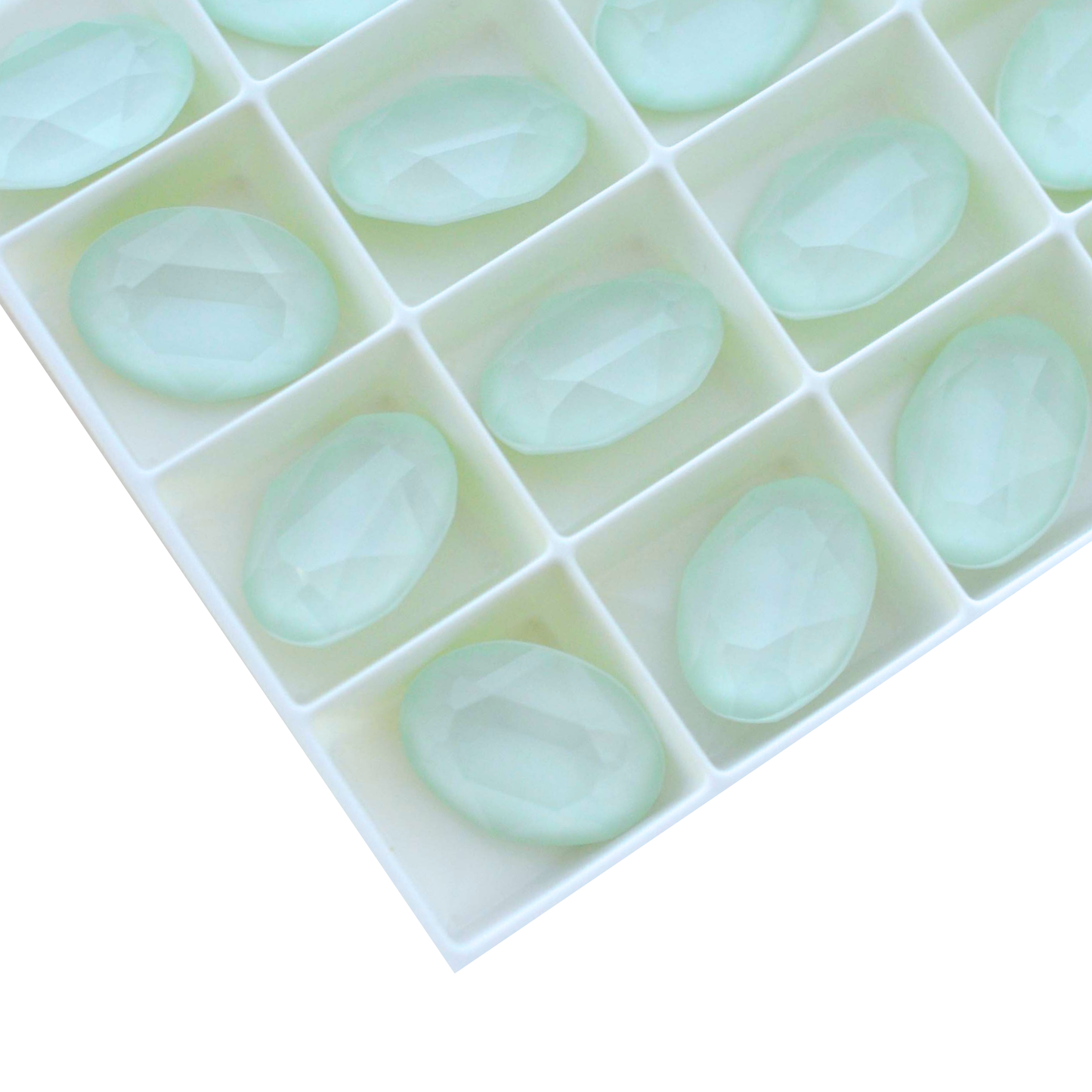 Oval shape faceted Austrian crystal rhinestones in the color Powder Green displayed on a white background.