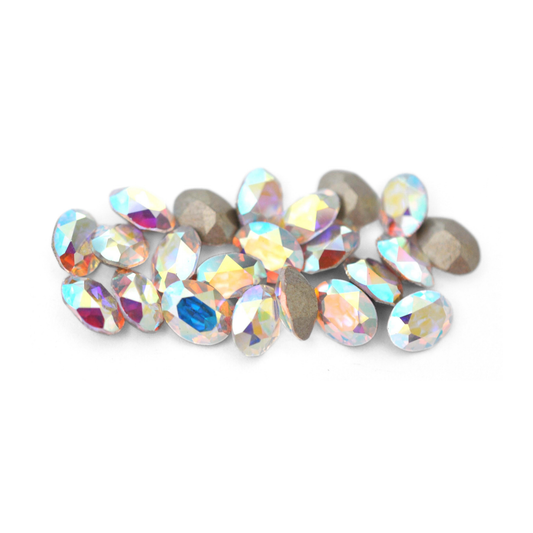 Oval shaped faceted Austrian crystal rhinestones in the color Crystal AB displayed on a white background. 