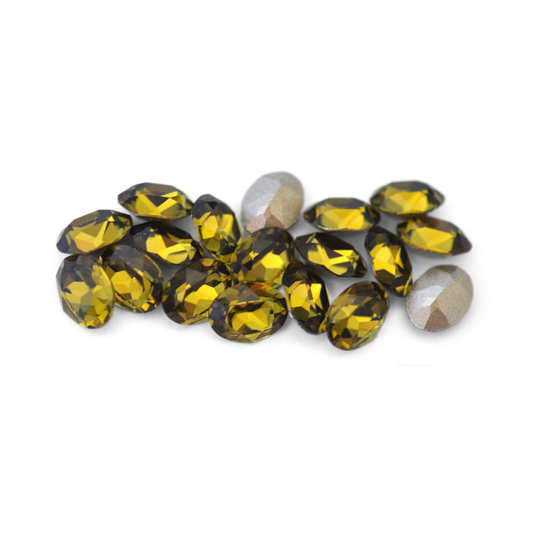 Oval shaped faceted Austrian crystal rhinestones in the color Khaki displayed on a white background. 