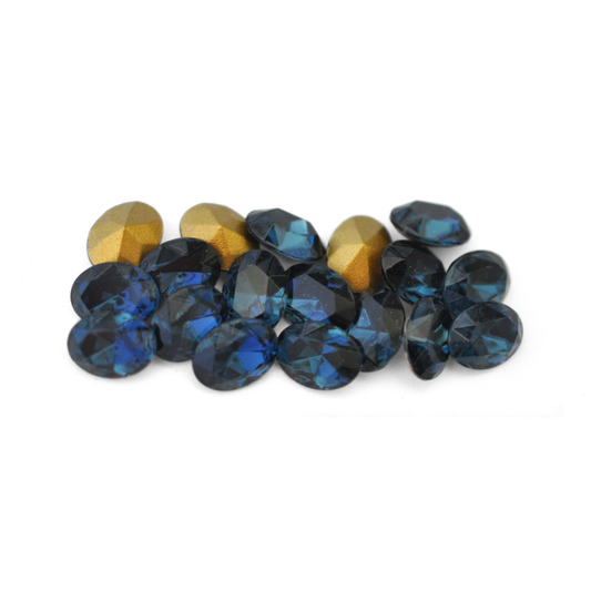 Oval shaped faceted Austrian crystal rhinestones in the color Montana displayed on a white background. 