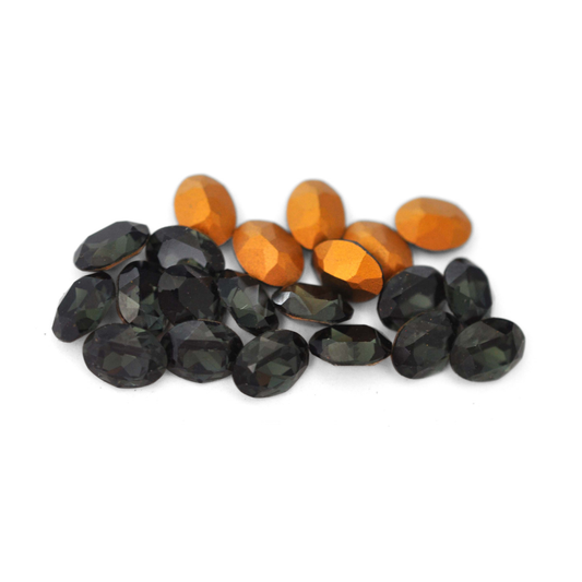 Oval shaped faceted Austrian crystal rhinestones in the color Morion displayed on a white background. 