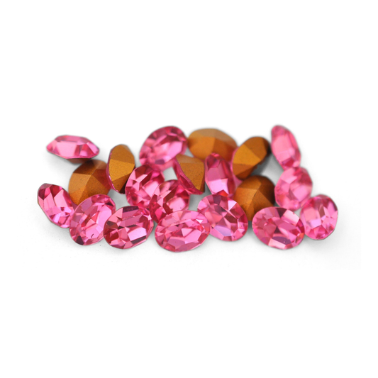 Oval shaped faceted Austrian crystal rhinestones in the color Rose displayed on a white background. 