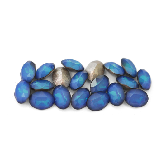 Oval shaped faceted Austrian crystal rhinestones in the color White Opal Sky Blue displayed on a white background. 