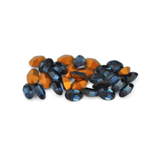 Oval shaped faceted Austrian crystal rhinestones in the color Montana displayed on a white background. 