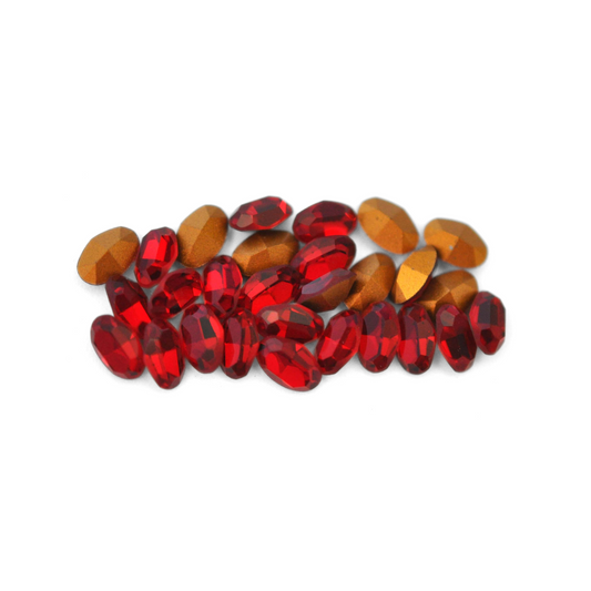 Oval shaped faceted Austrian crystal rhinestones in the color Siam displayed on a white background. 