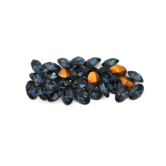 Oval shaped faceted Austrian crystal rhinestones in the color Montana displayed on a white background. 