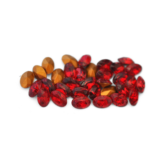 Oval shaped faceted Austrian crystal rhinestones in the color Siam displayed on a white background. 