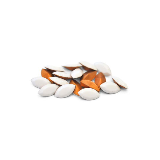 Navette shaped faceted Austrian crystal rhinestones in the color Chalk White displayed on a white background.