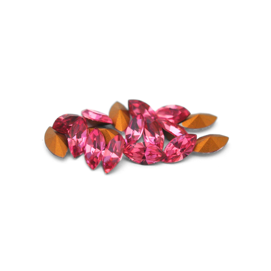 Navette shaped faceted Austrian crystal rhinestones in the color Rose displayed on a white background.