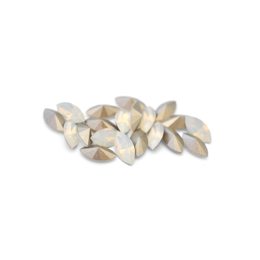 Navette shaped faceted Austrian crystal rhinestones in the color White Opal displayed on a white background.