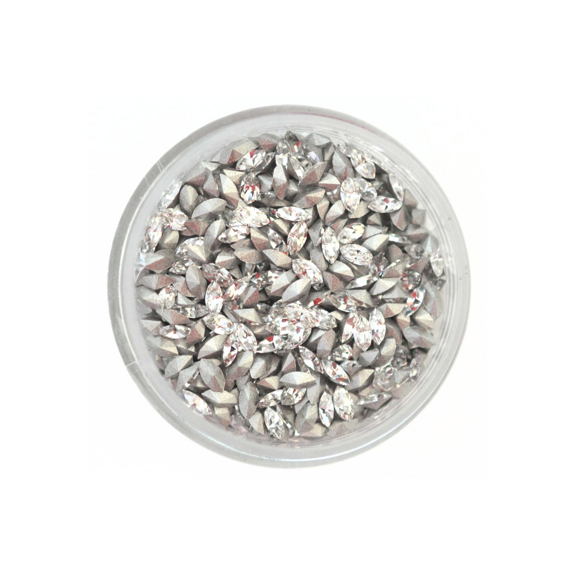 Navette shaped faceted Austrian crystal rhinestones in the color Crystal displayed in a round dish on a white background.
