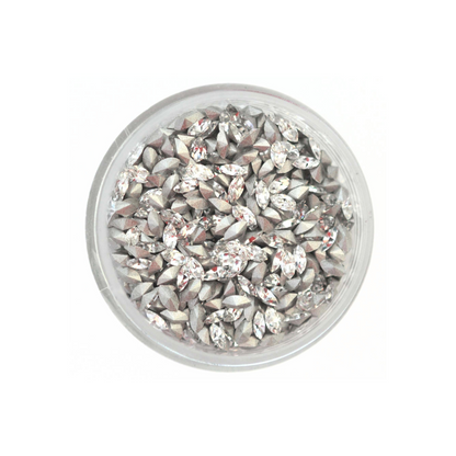 Navette shaped faceted Austrian crystal rhinestones in the color Crystal displayed in a round dish on a white background.